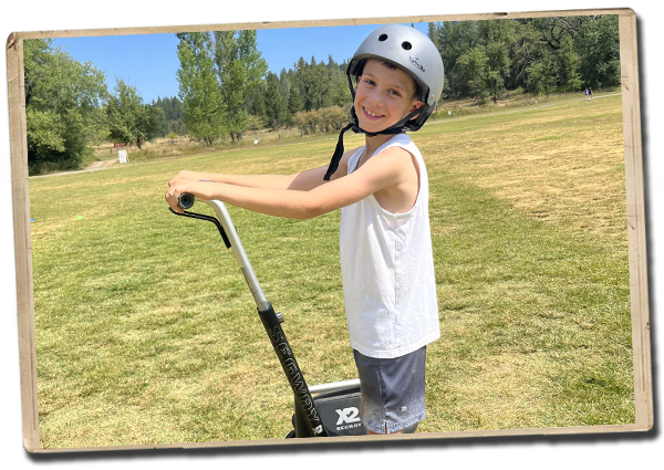 a camper smiling for the camera on a segway